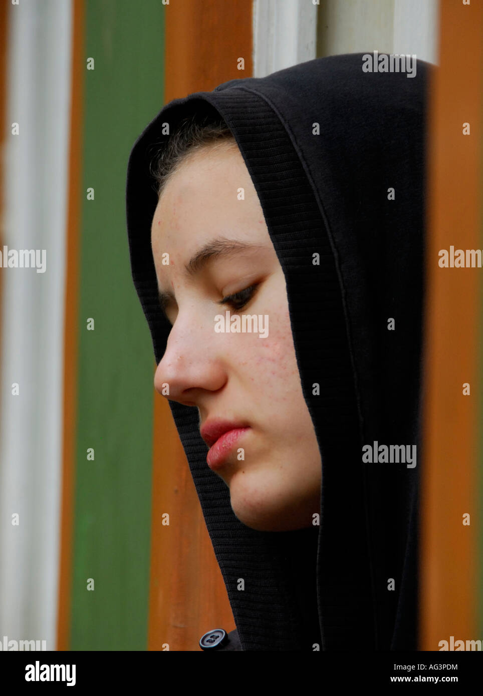 Young girl with black shawl standing pensively in doorframe, South Africa Stock Photo