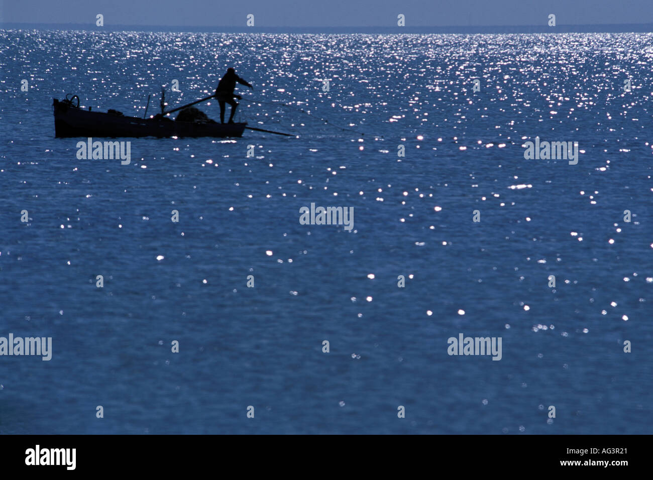 TUNISIA fisherman casting from boat in Mediterranean Stock Photo