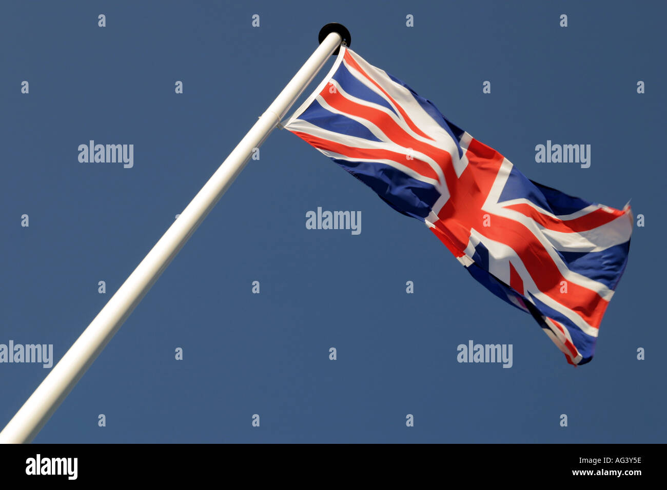 Union jack flag against blue sky Stock Photo - Alamy