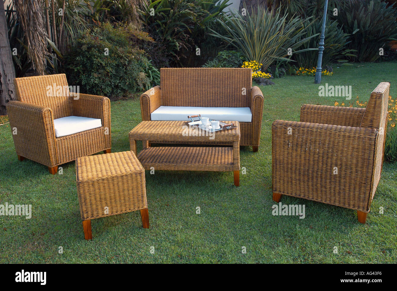 Rattan garden chairs and table set Stock Photo - Alamy