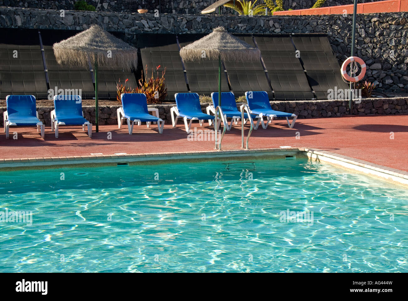 Swimming pool heated by solar panels Stock Photo - Alamy