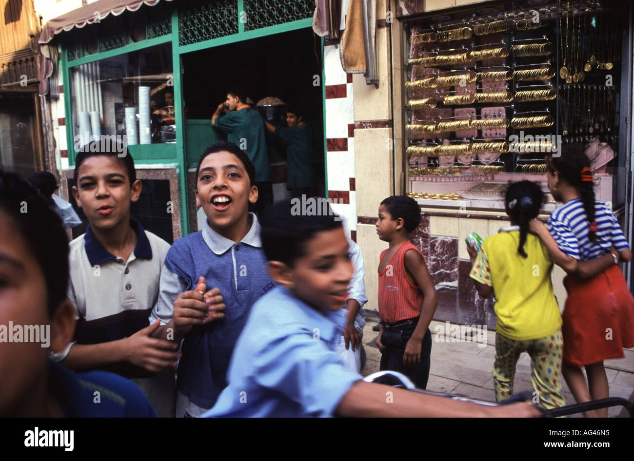 Cheeky Kids play in the back alleys of Cairo. With high rates of population growth a common sight throughout the Arab world. Stock Photo