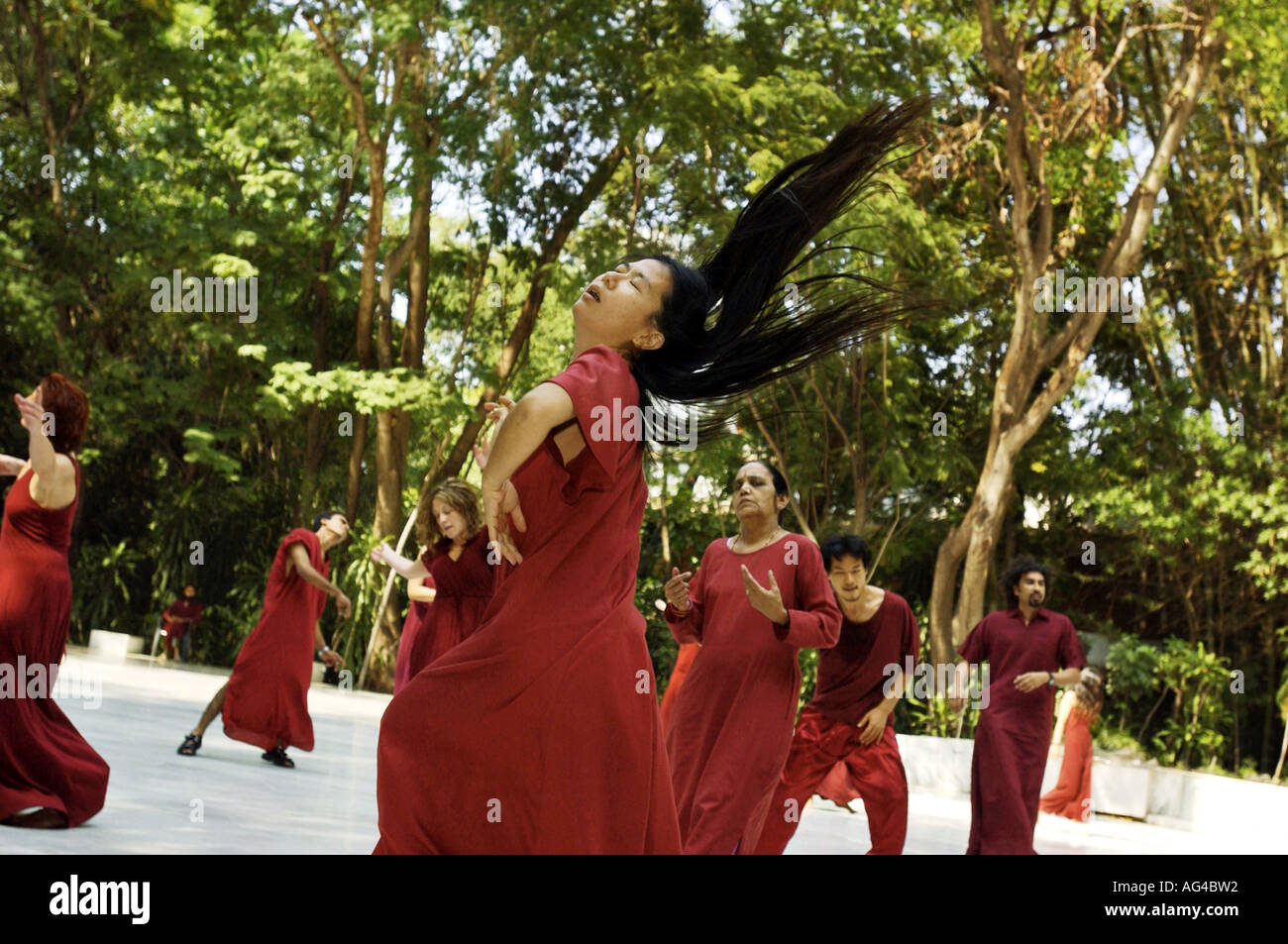 Bhagwan Acharya Rajneesh Osho followers dancing in a trance after meditation at the commune in Poona Pune Maharashtra India Asia Indian meditation Stock Photo