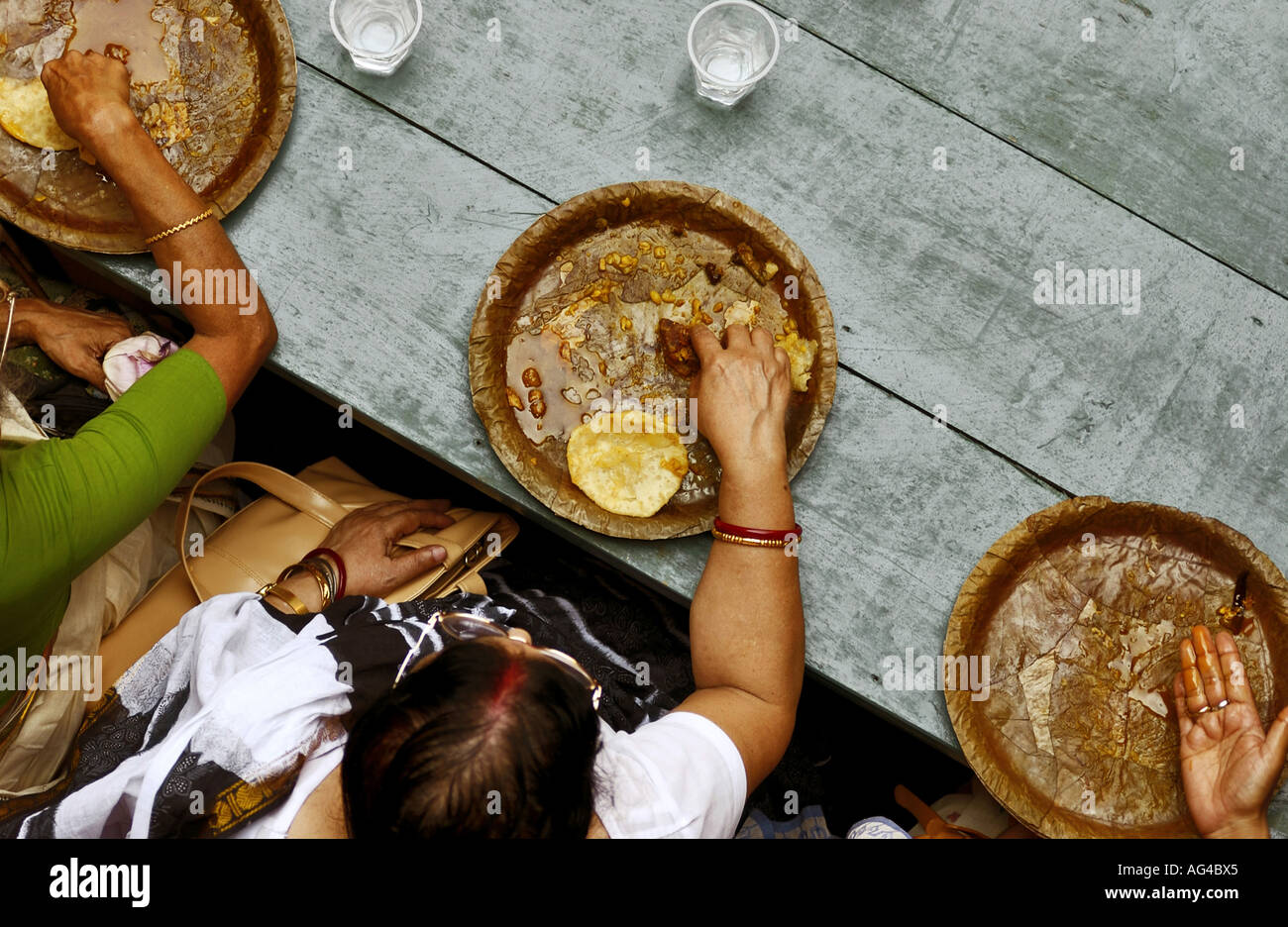 Ashtami Bhog on tendu leaves devotees eat prasad after Ashtami prayers at Malikbari in Kolkata West Bengal India Stock Photo