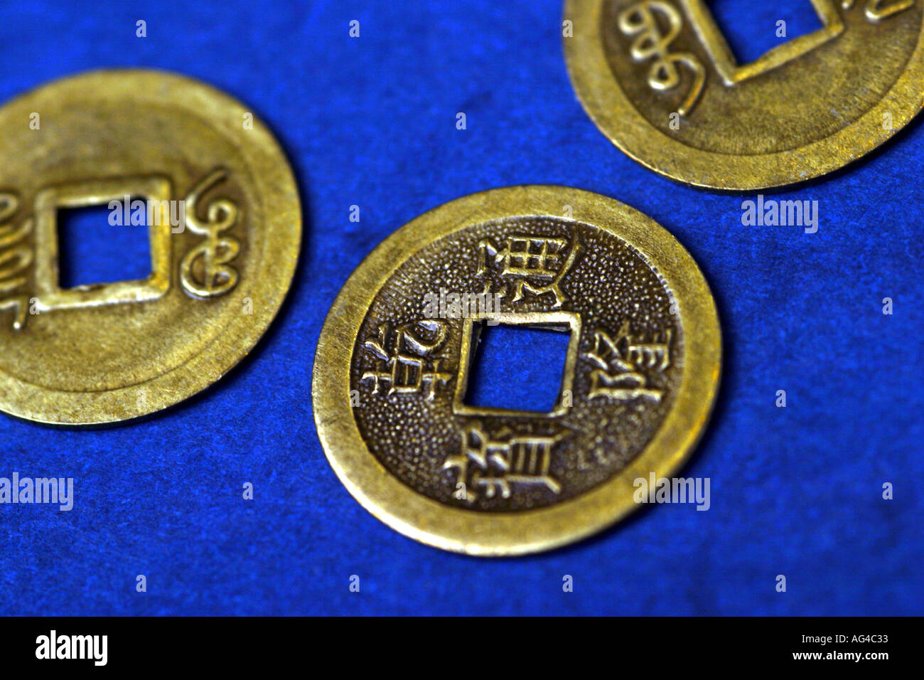 3 I ching coins on a blue background Stock Photo