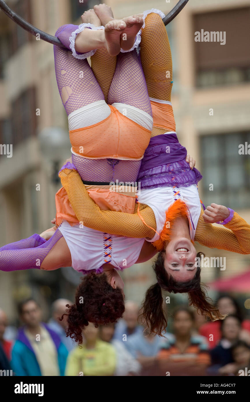 Two Female Acrobats Hold Each Other As They Hang Upside Down In Gran