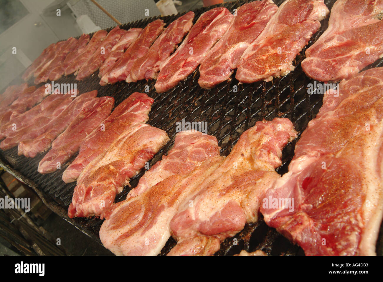 meat cooking on bbq fast food fat diet bad aktins obesse over weight male interest barbarque beef steak heart attack red meat c Stock Photo
