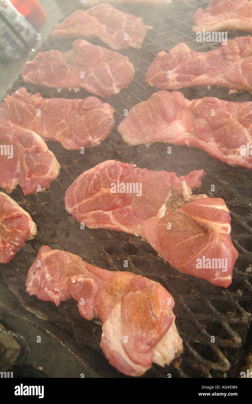 meat cooking on bbq fast food fat diet bad aktins obese over weight male interest barbecue beef steak heart attack red meat Stock Photo