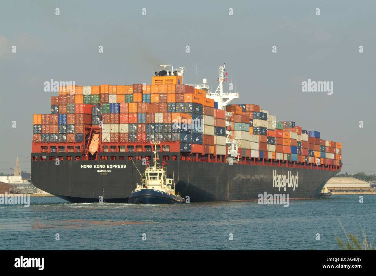 Southampton Container Terminal Tug Svitzer Sarah pulling Hong Kong Express a container ship operated by Hapag Lloyd Stock Photo