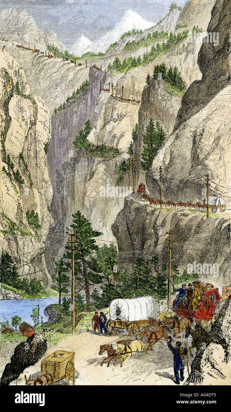 Stagecoaches and covered wagons crossing the Sierra Nevada mountains into California 1865. Hand-colored woodcut Stock Photo