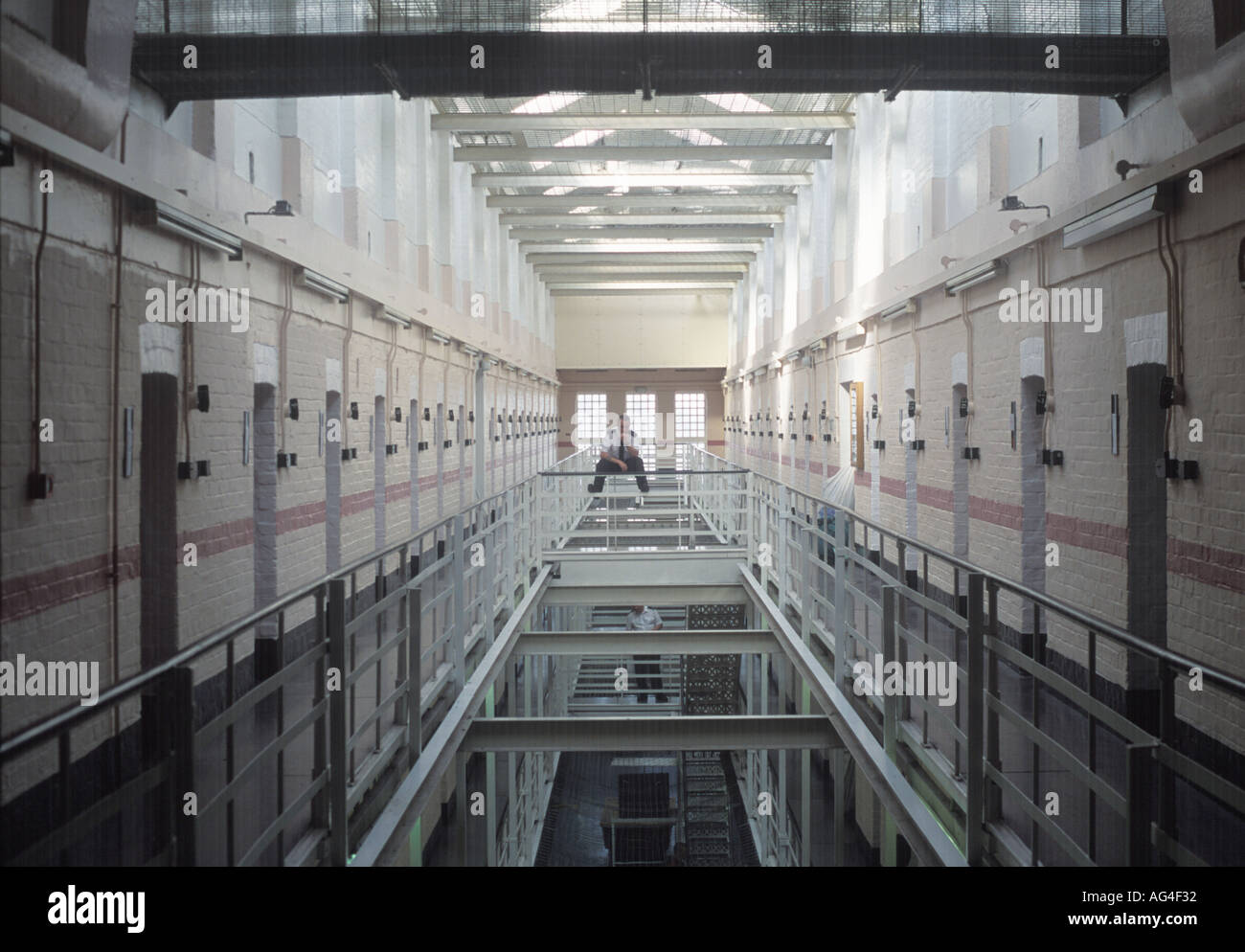 A lone prison officer on a prison wing at Winchester Prison, UK. Stock Photo