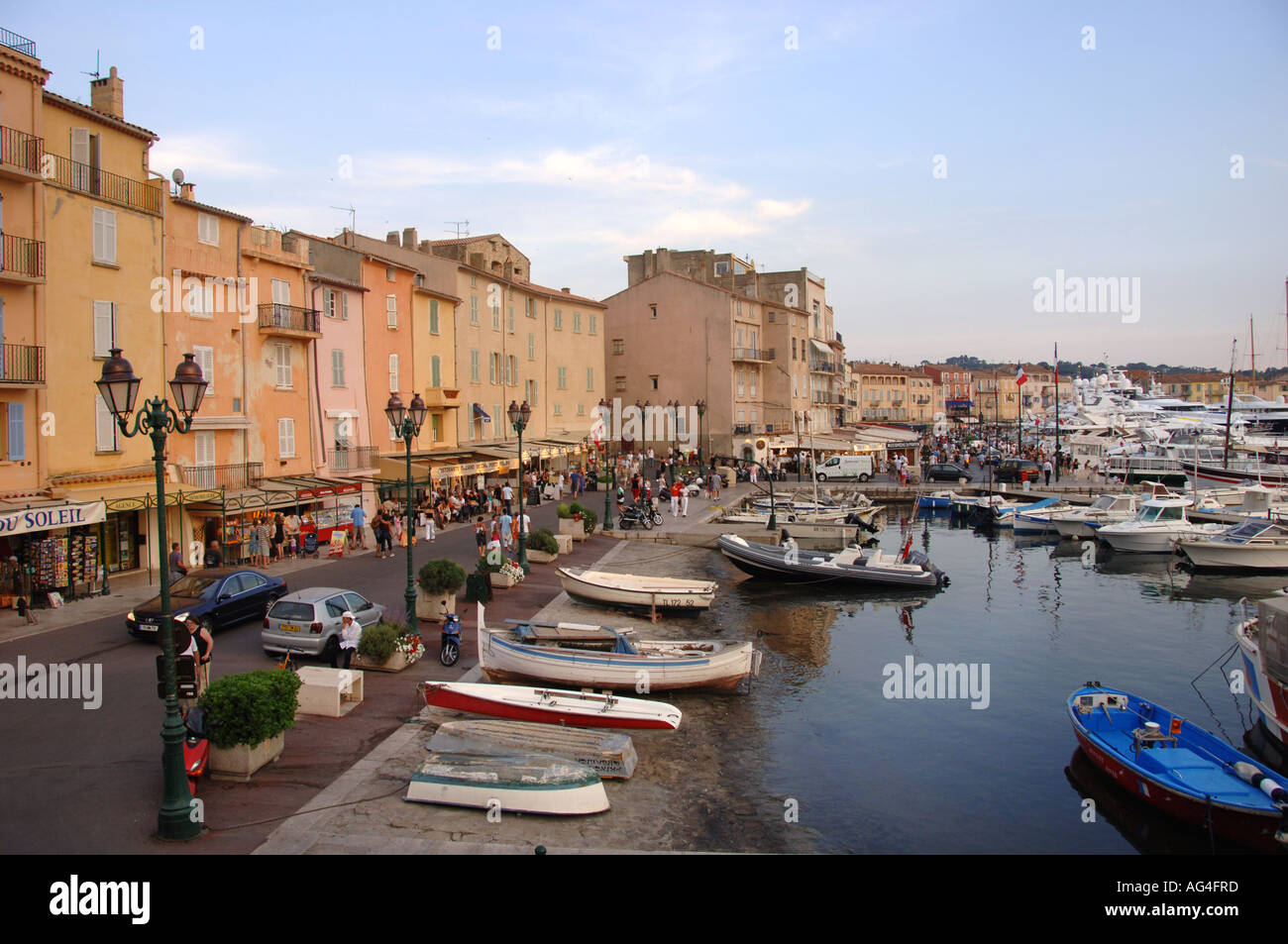 A view of the beautiful Saint Tropez harbour taken in the late sun with ...