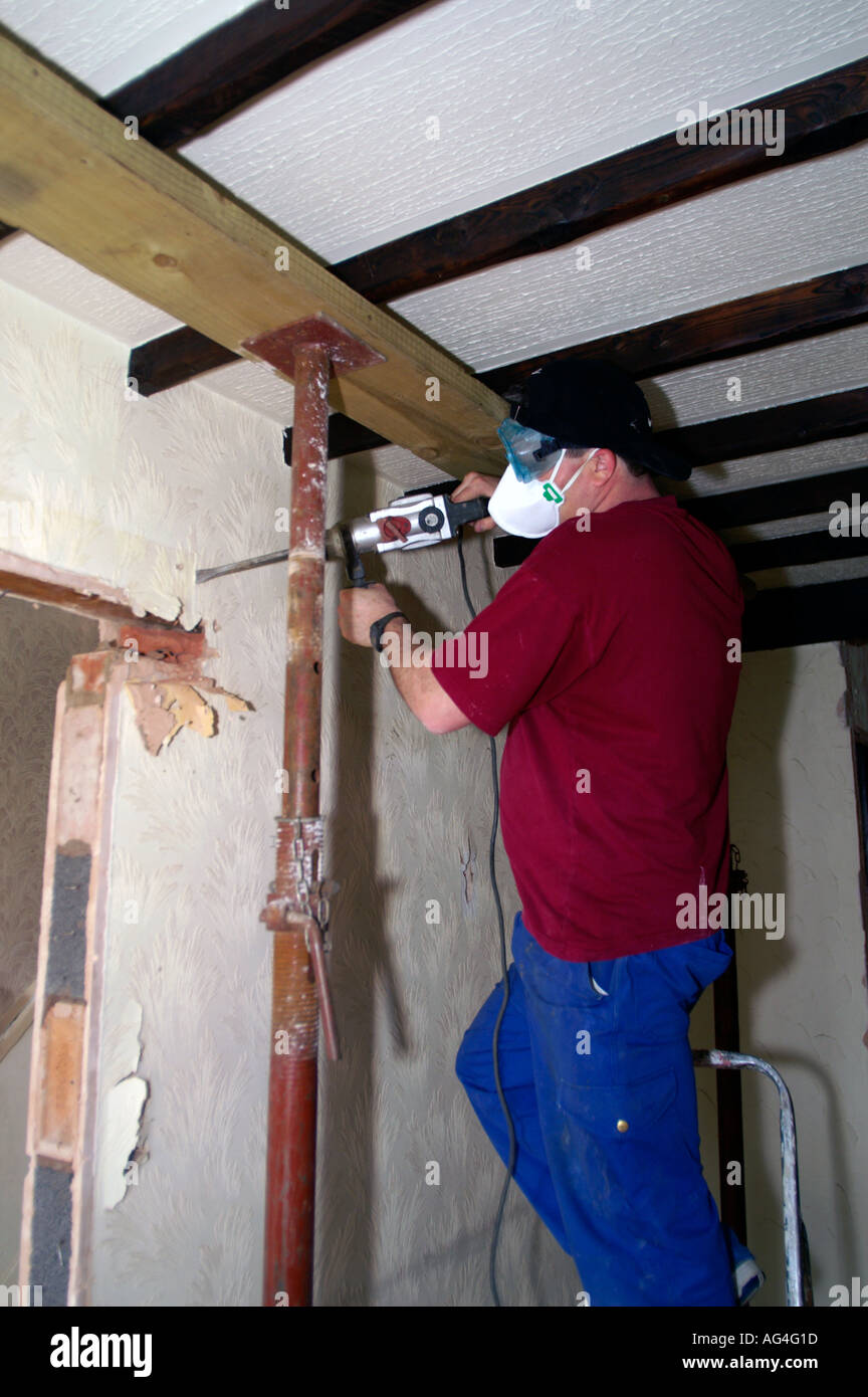 Builder Removing Interior Wall Of A House Stock Photo