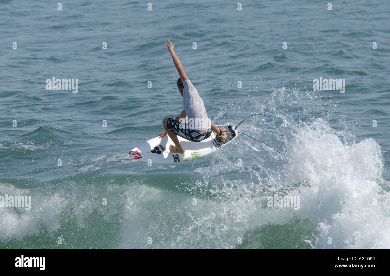 Pro surfer Dane Reynolds performing an aerial maneuver on waves in huntington beach California Stock Photo