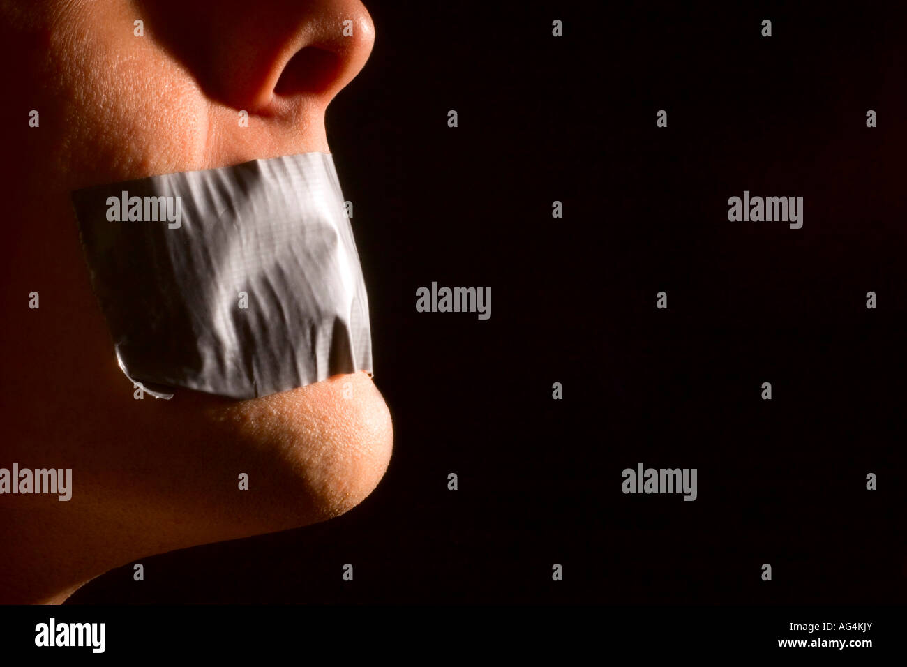 Person with tape over their mouth Stock Photo Alamy