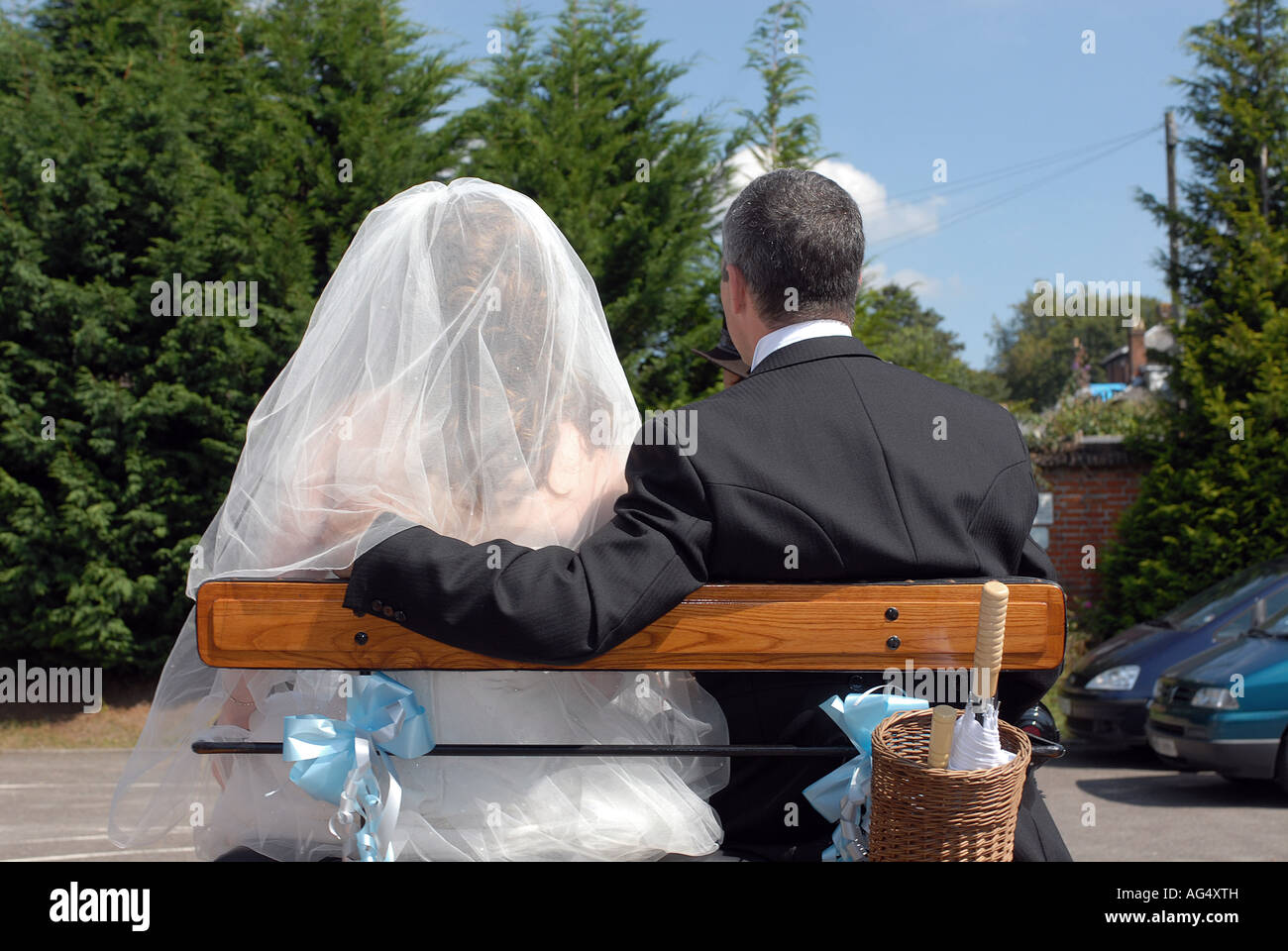 bride and father groom arriving at the church on wedding day on horse drawn carriage Stock Photo