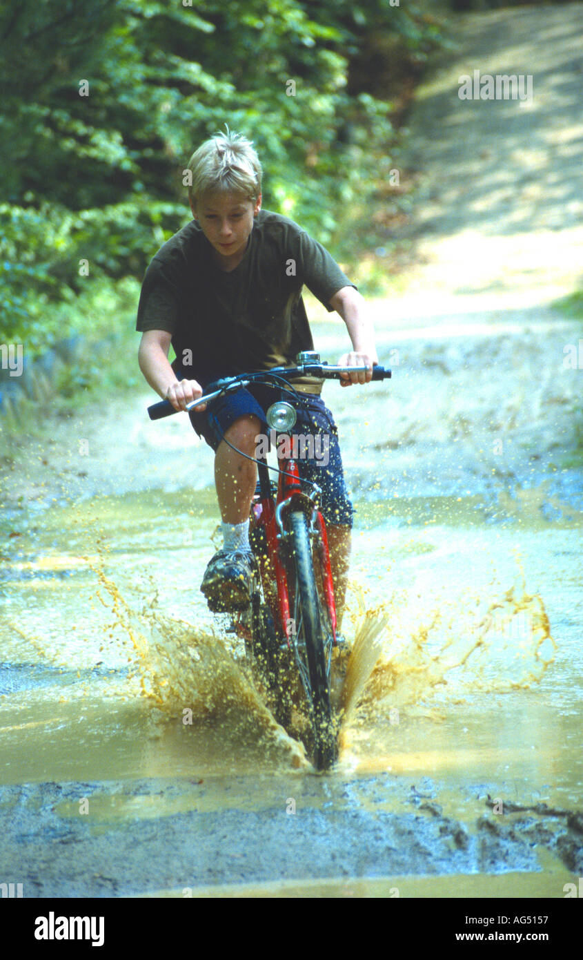 Boy on bike splashing through puddle Centre Parcs Center Parcs Parcs