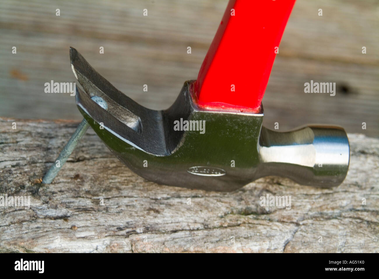 Claw hammer pulling large nail Stock Photo