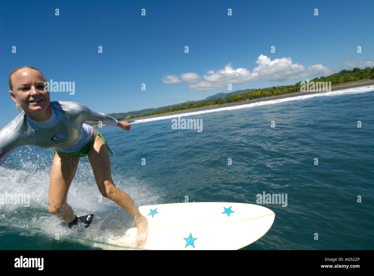 Blonde woman surfing Stock Photo