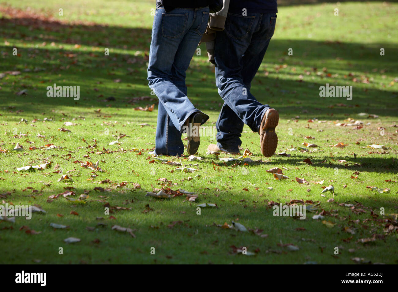 lower half of a couple wearing jeans 