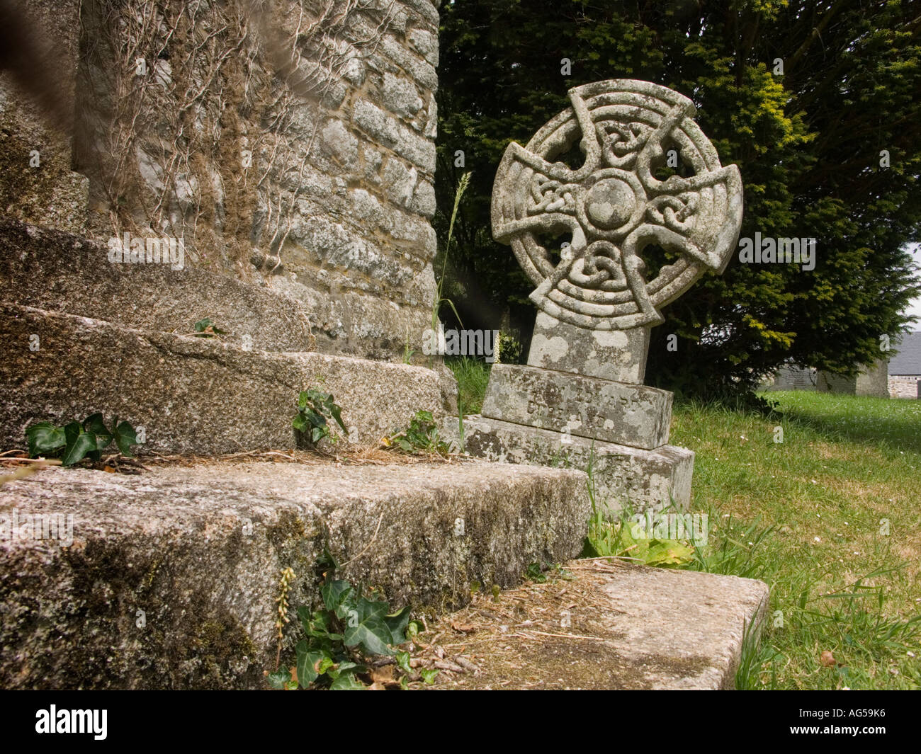 Gravestone in the shape of a Celtic cross in a Cornish churchyard Stock Photo