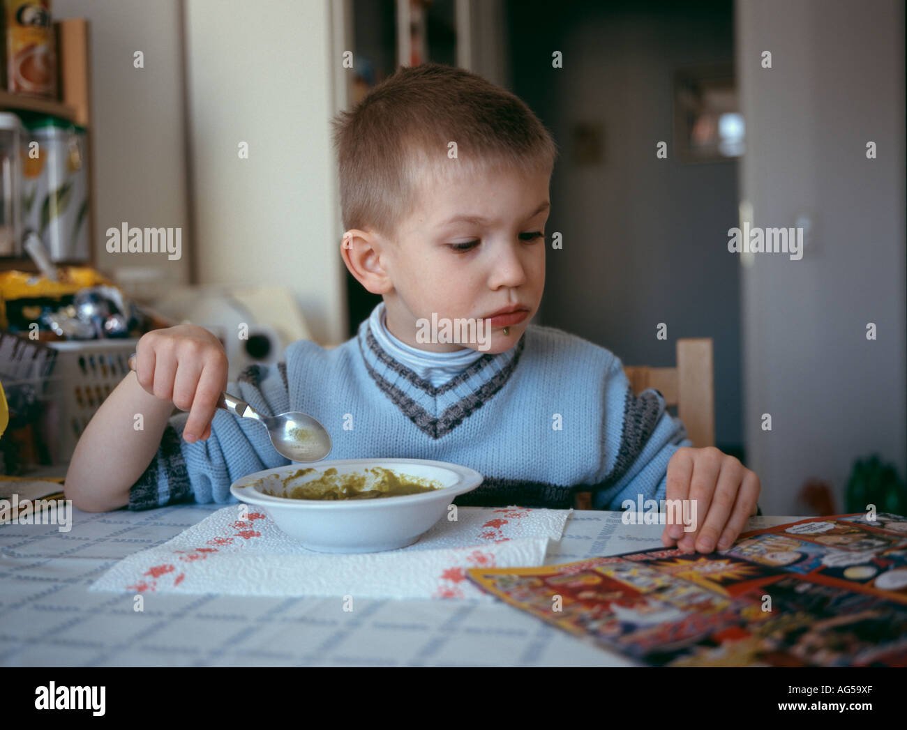Boy eating spinach Stock Photo Alamy