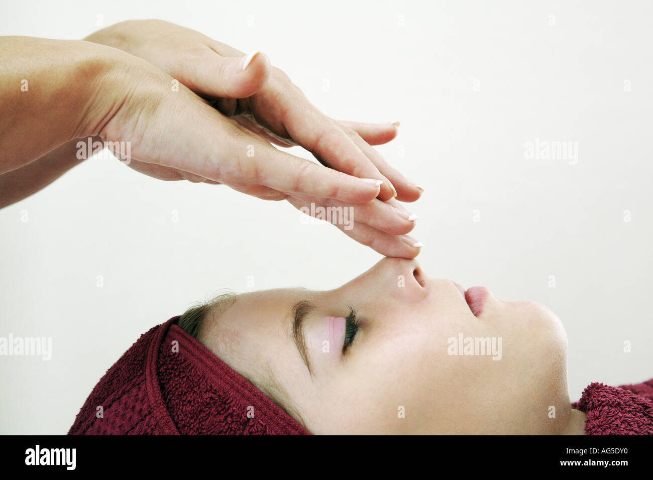 young woman getting a face massage Stock Photo