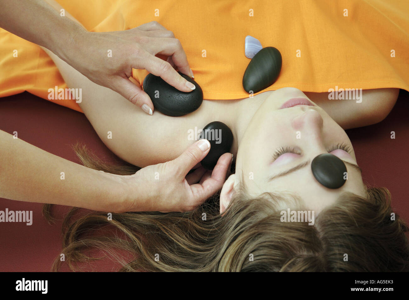 young woman getting a massage with hot stones Stock Photo