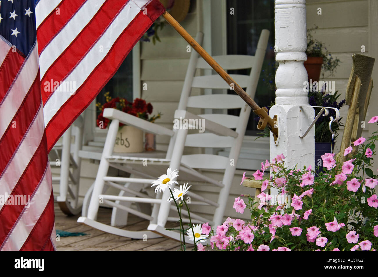 American Flag and Soft Focus Rocking Chair on Porch of Victorian ...