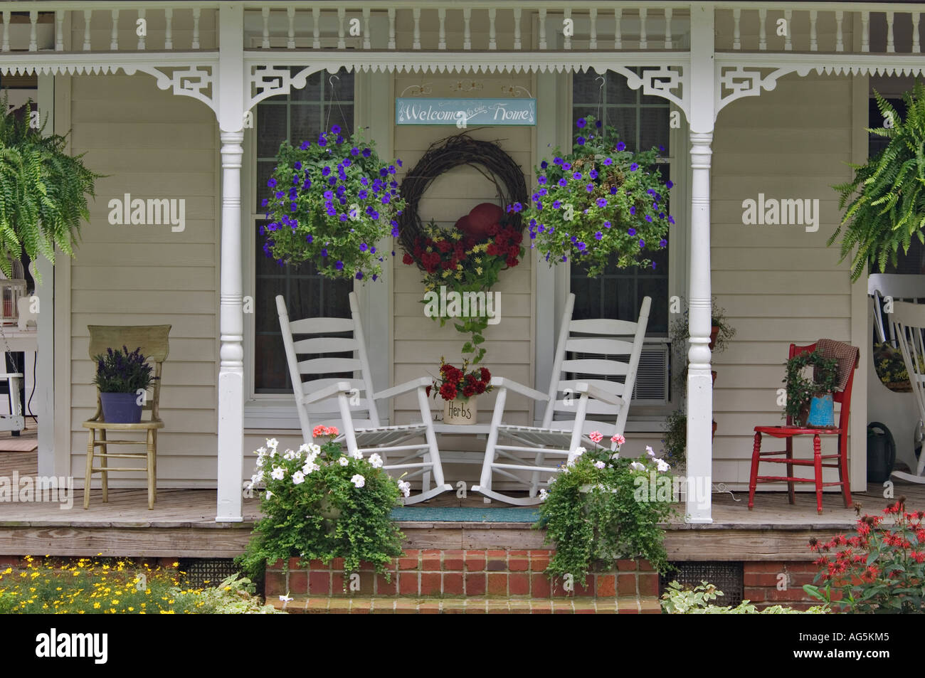 Rocking Chairs on Front Porch of Decorated Victorian Cottage Stock