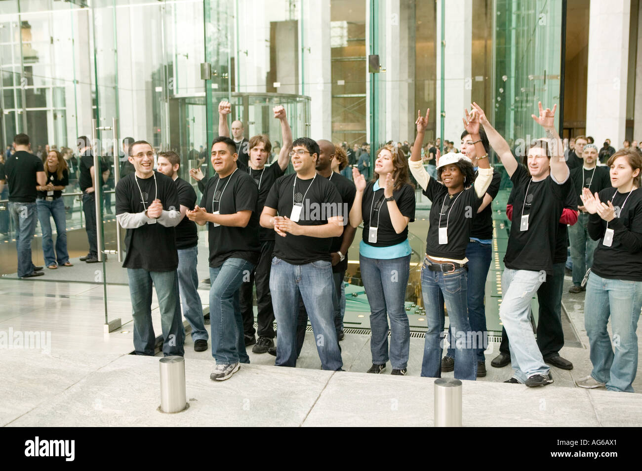 Apple employees cheer to welcome clients entering the Apple store cube on 5th Ave in New York City USA 19 May 2006 Stock Photo