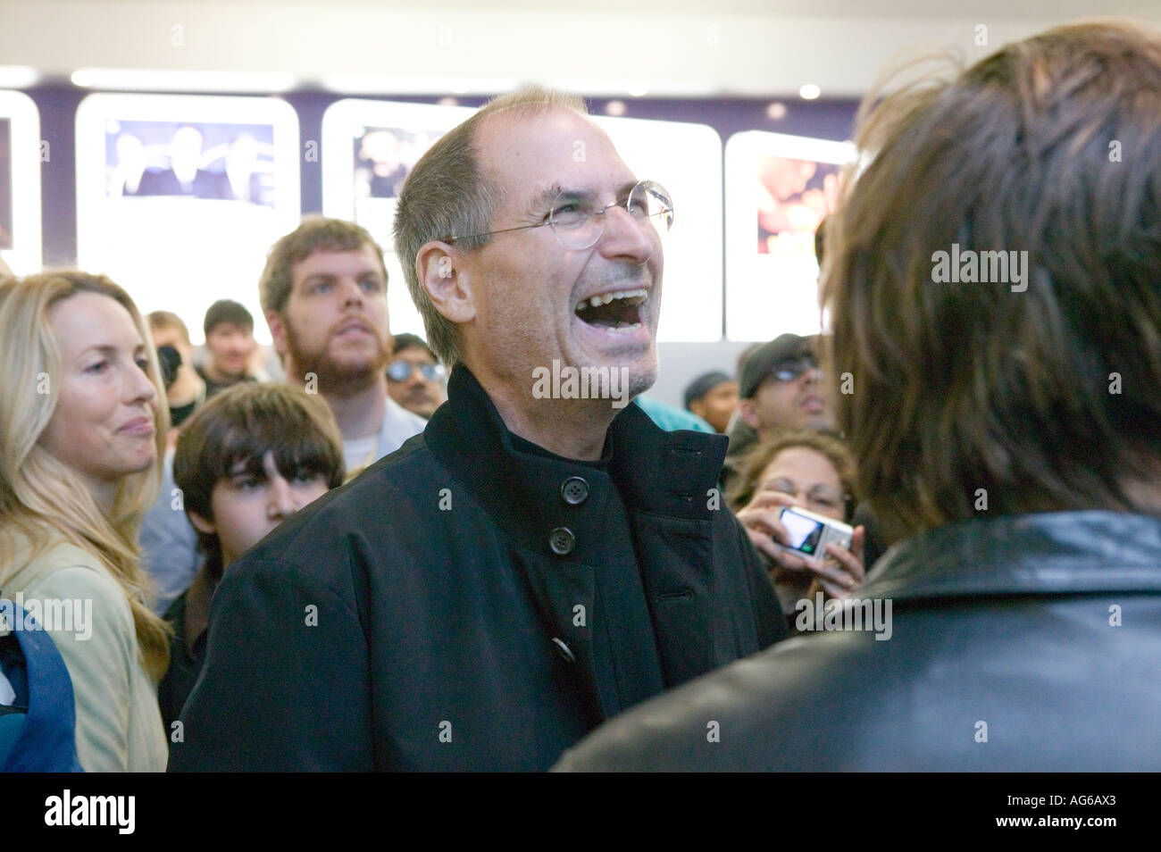 Steve Jobs laughs as his wife Laurene Powell looks on in the Apple store on 5th Ave in New York City USA 19 May 2006 Stock Photo