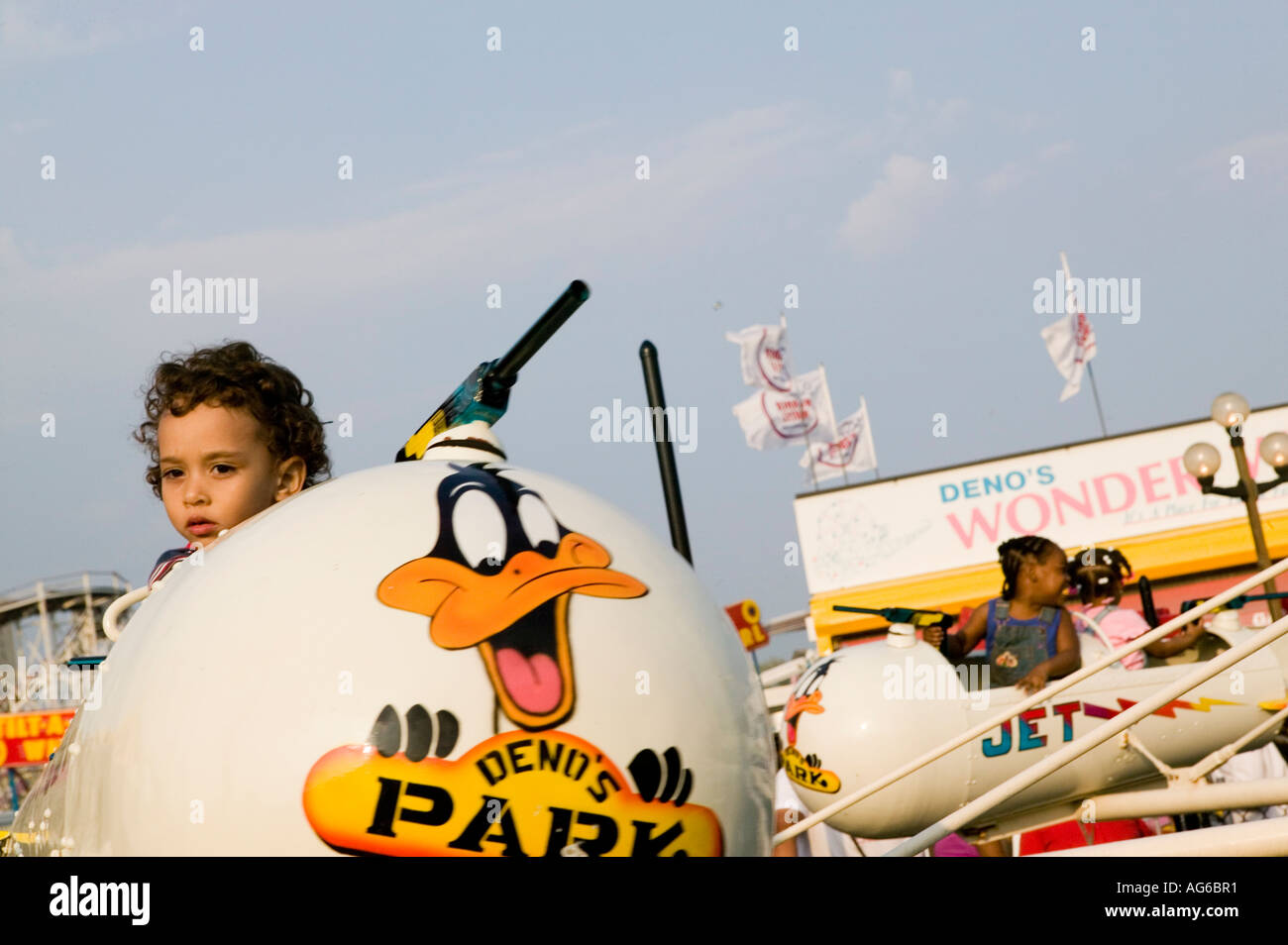 Kids enjoy a jet rocket ride at Coney Island fairground in New York ...