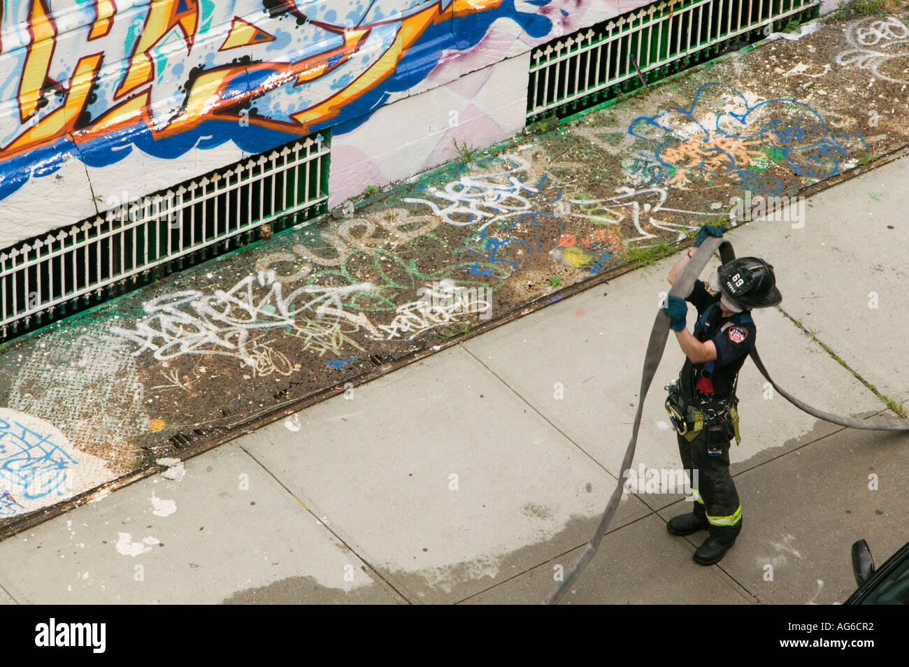 FDNY firemen put hoses away after an apartment building fire in Harlem