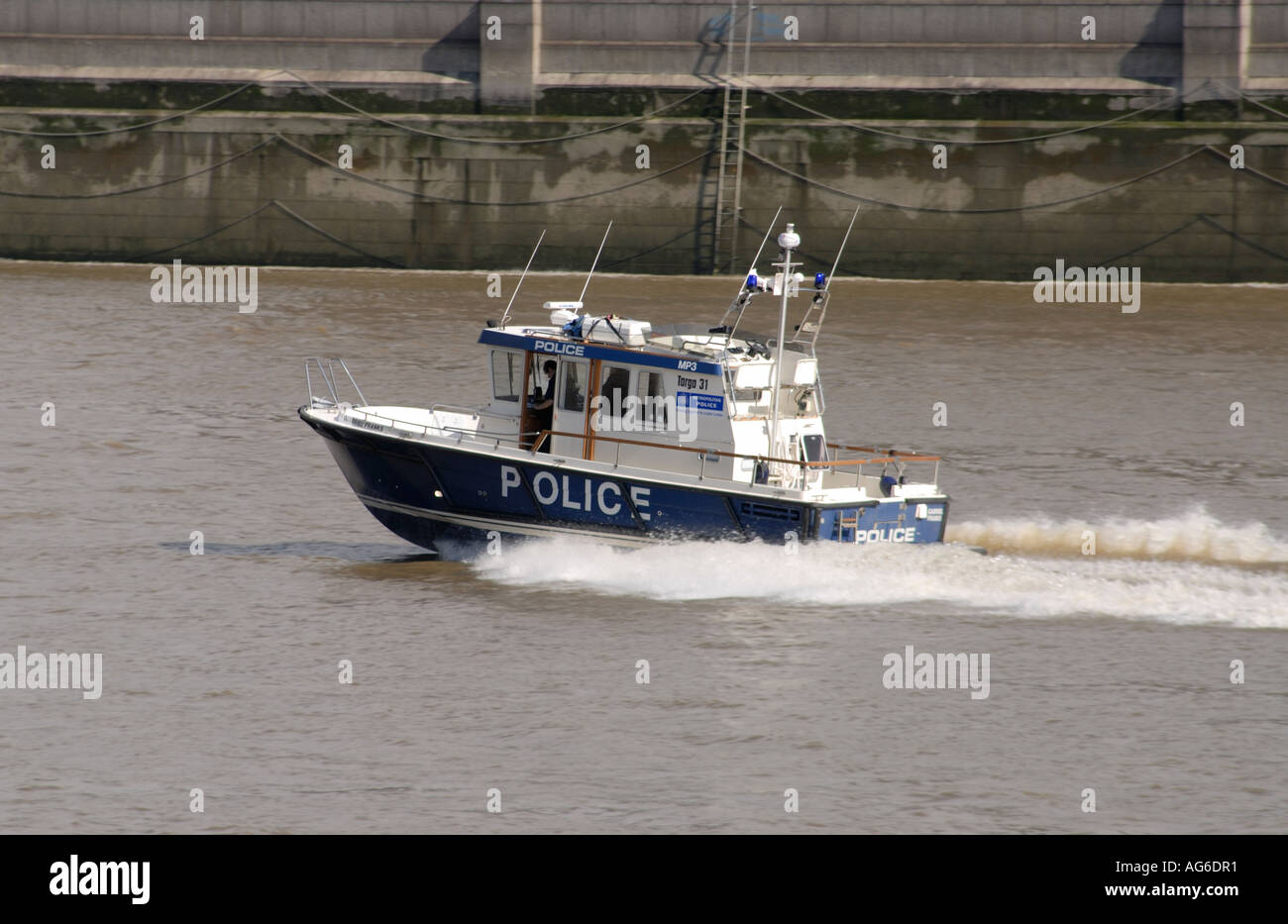 A river police boat speeds up the River Thames towards Blackfriars Bridge City of London UK 28 June 2006 Stock Photo