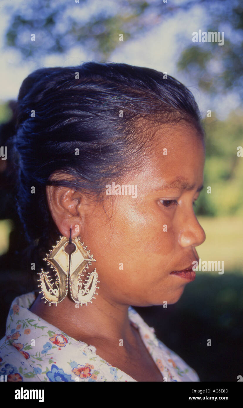 Indonesia Sumba Woman wearing the traditional gold mamuli earring Stock Photo
