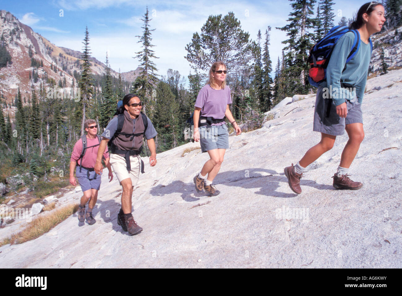 Group Of Hikers Walking Up A Steep Mountain Rock Stock Photo - Alamy