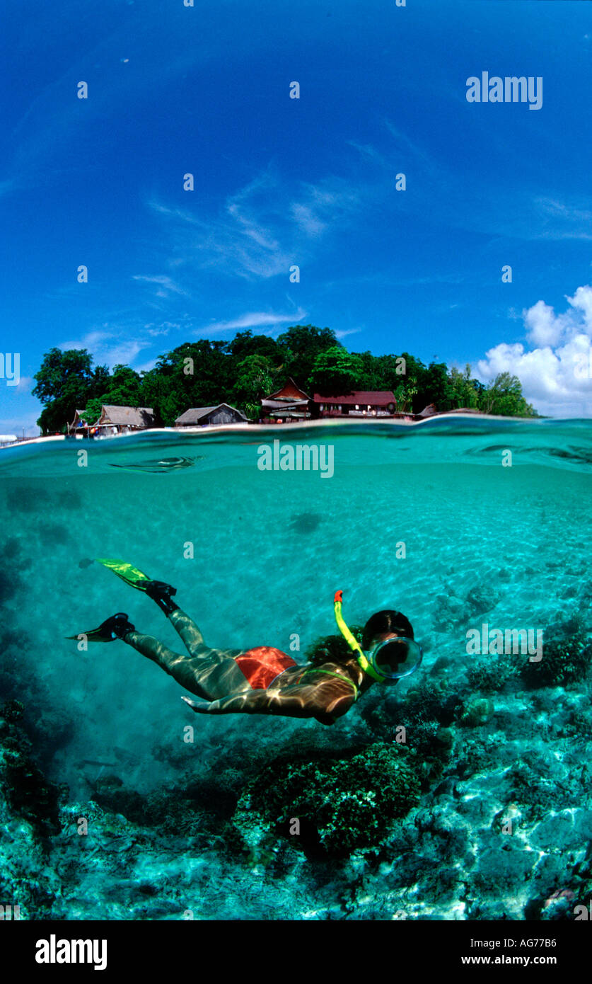 A young woman snorkels near a tropical island Malaysia Borneo Sabah