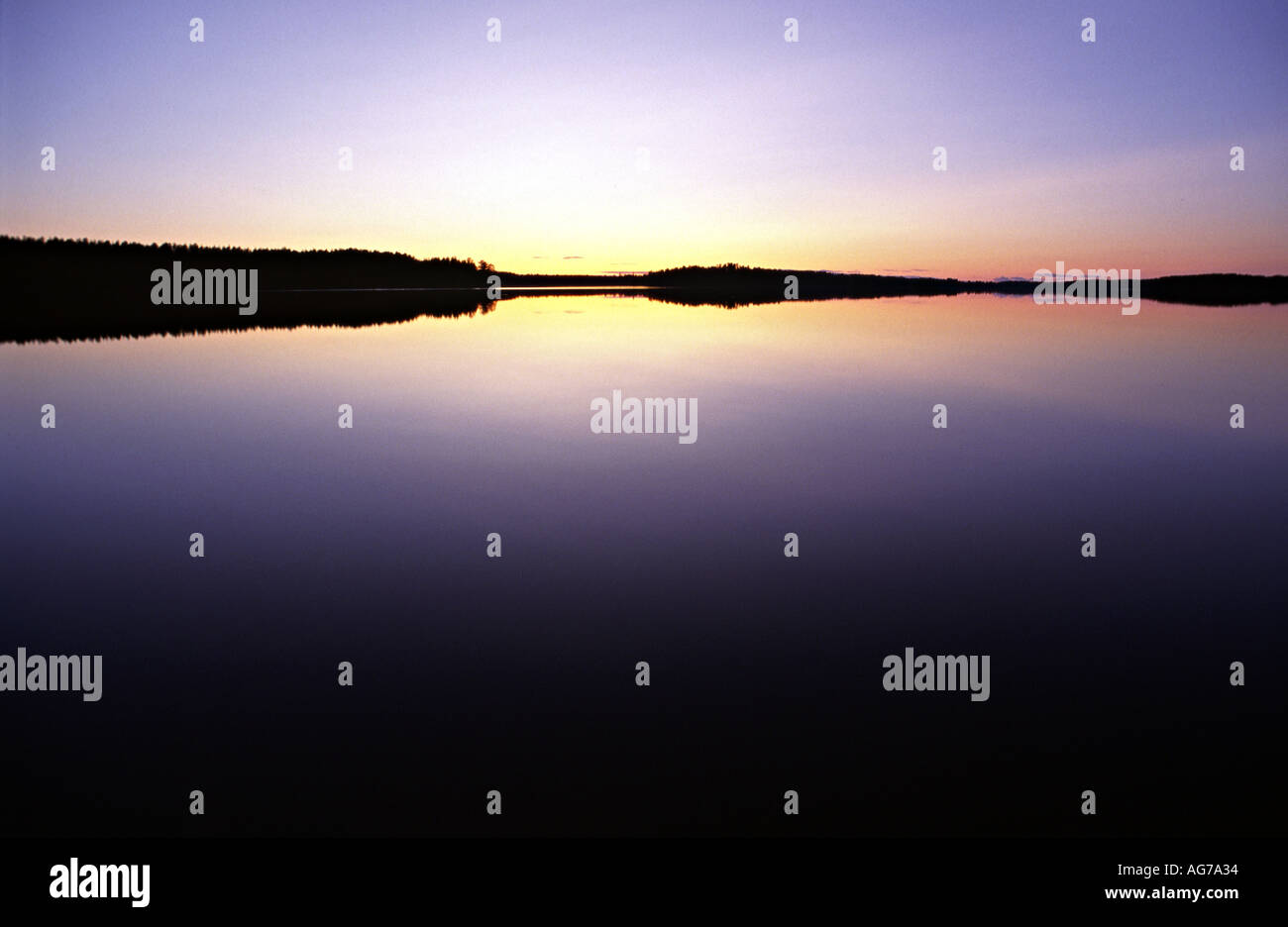 midnight sun over a lake Stock Photo