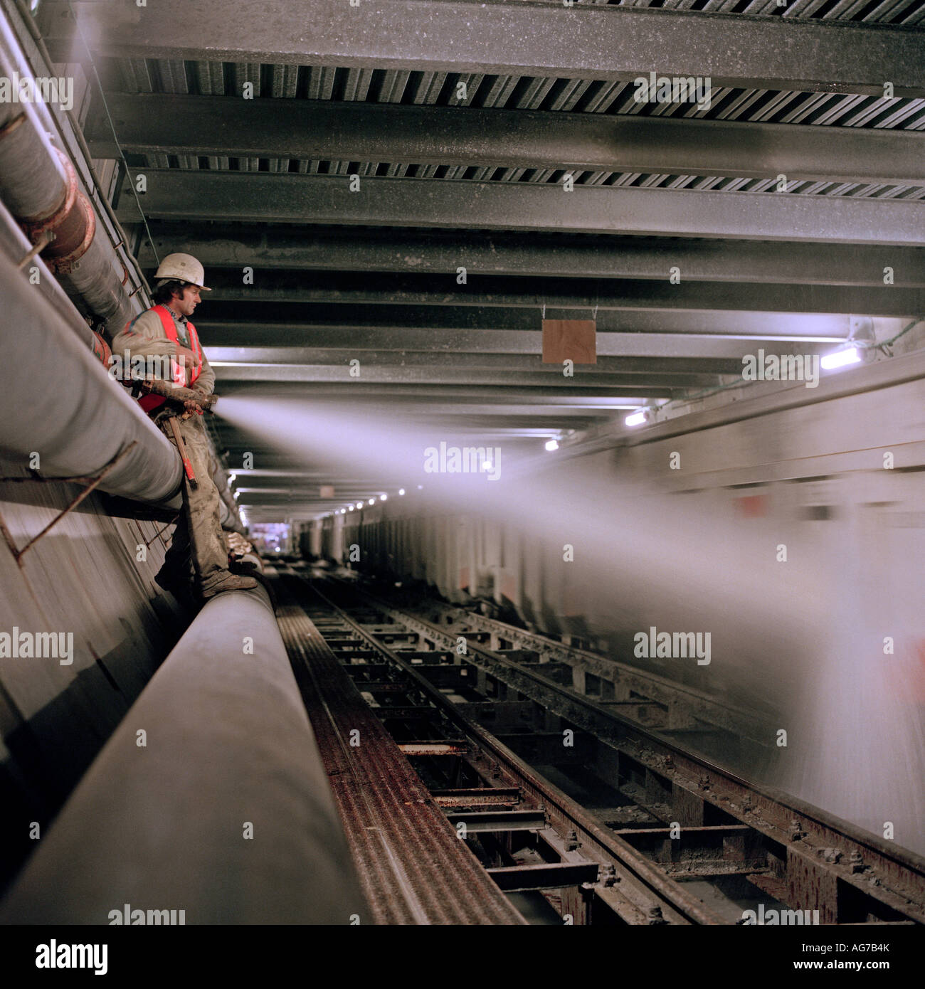 Channel Tunnel worker washing a construction train before it collects ...