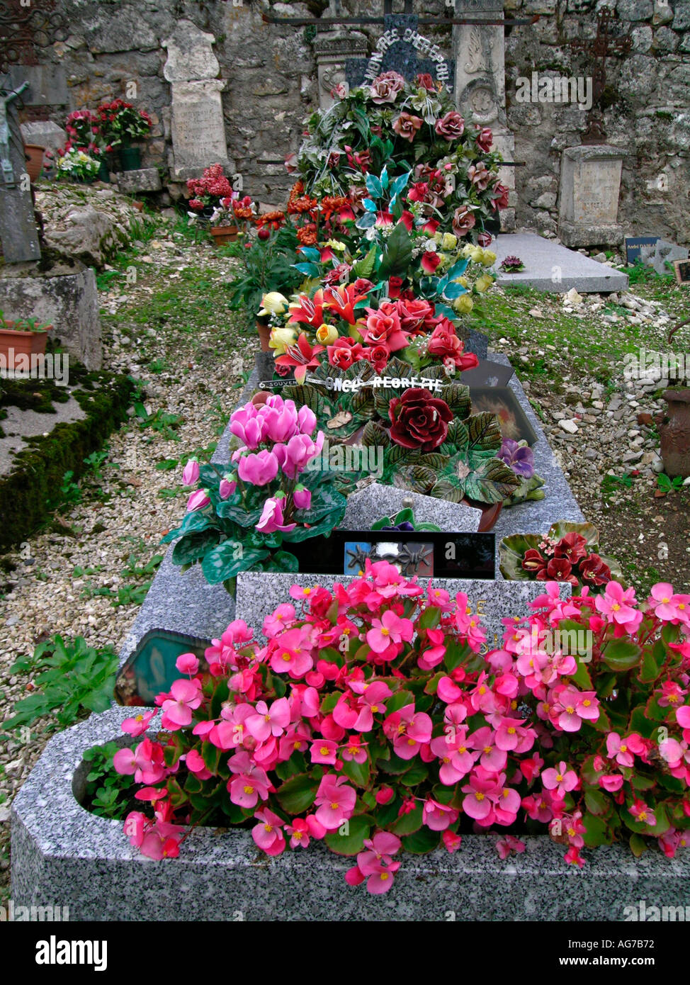 real and artificial flowers as grave decoration Stock Photo - Alamy