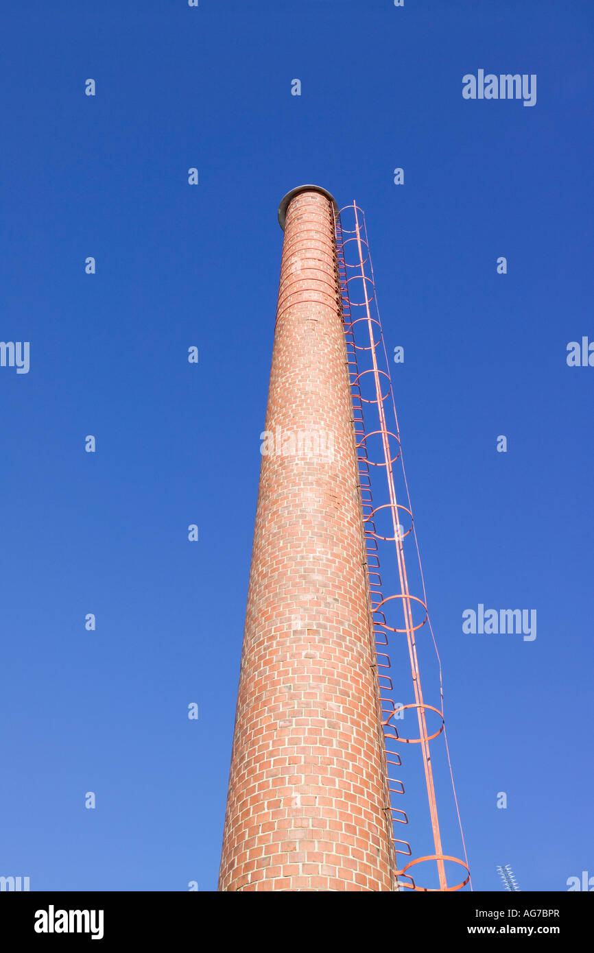 red brick chimney against blue sky Stock Photo - Alamy
