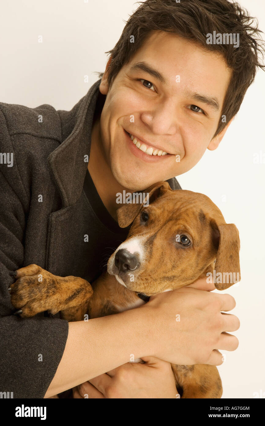 Man holding a dog Stock Photo