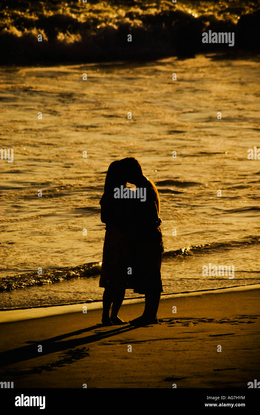 Silhouette of couple on beach Stock Photo - Alamy