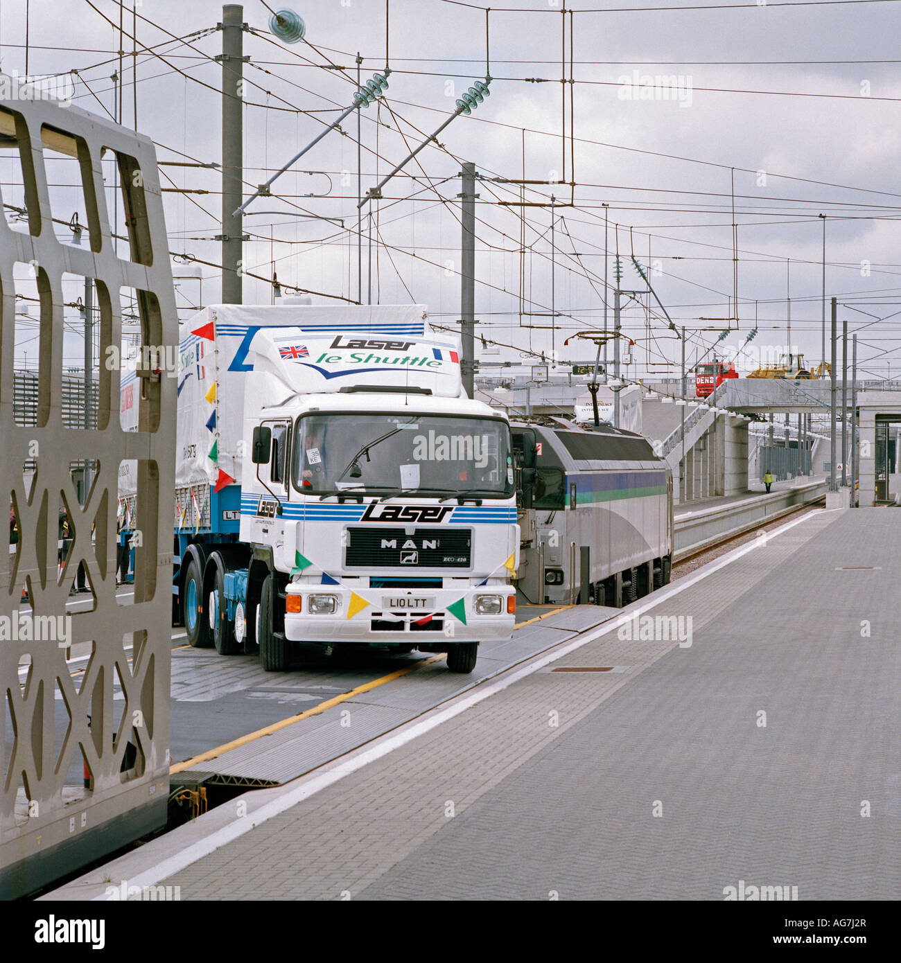 The first HGV truck to travel through the Channel Tunnel is loaded onto