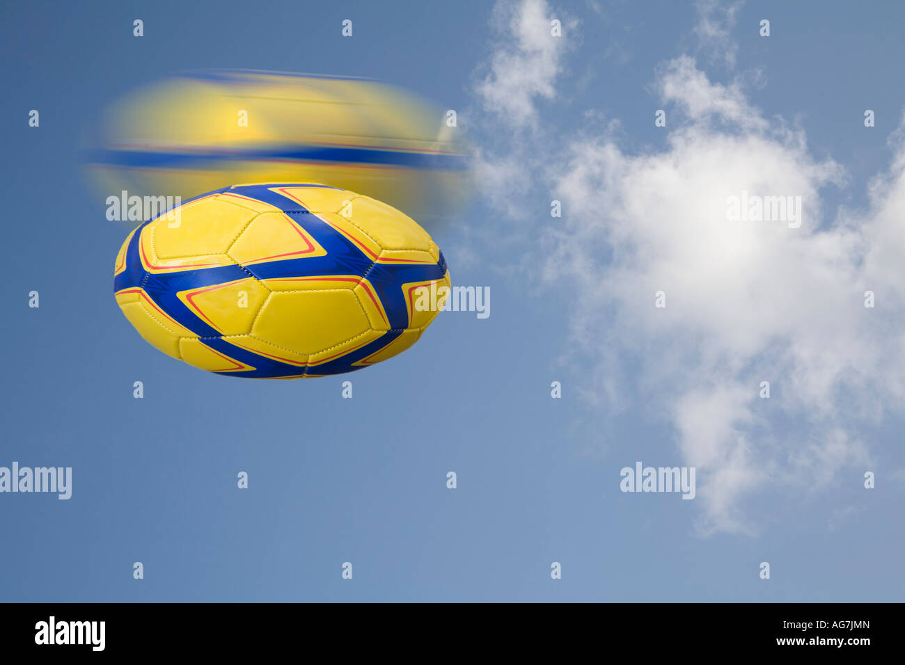 STUDIO A yellow and blue rugby ball falling down Stock Photo Alamy