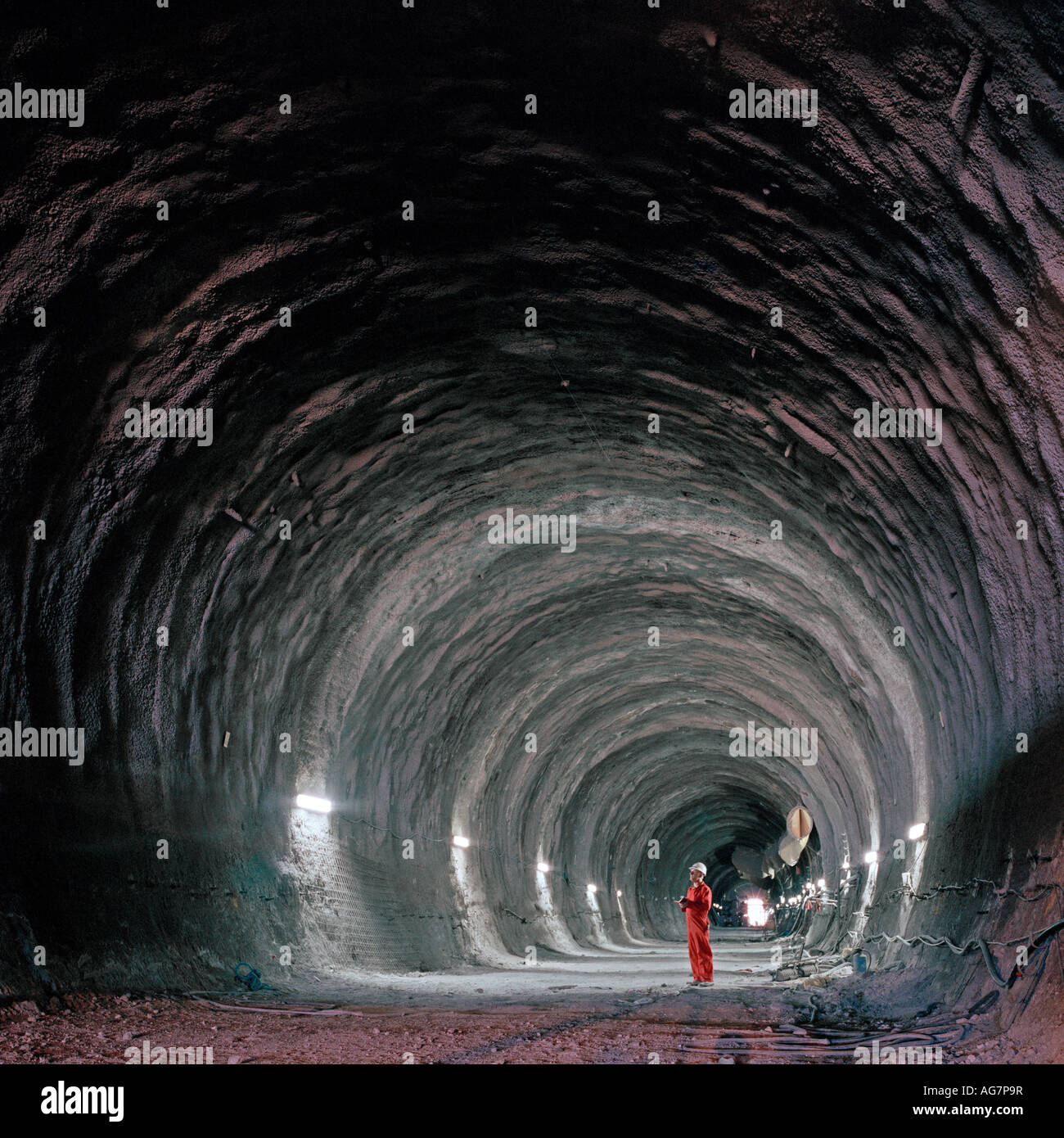 Channel Tunnel Engineer examines a section of rail tunnel constructed