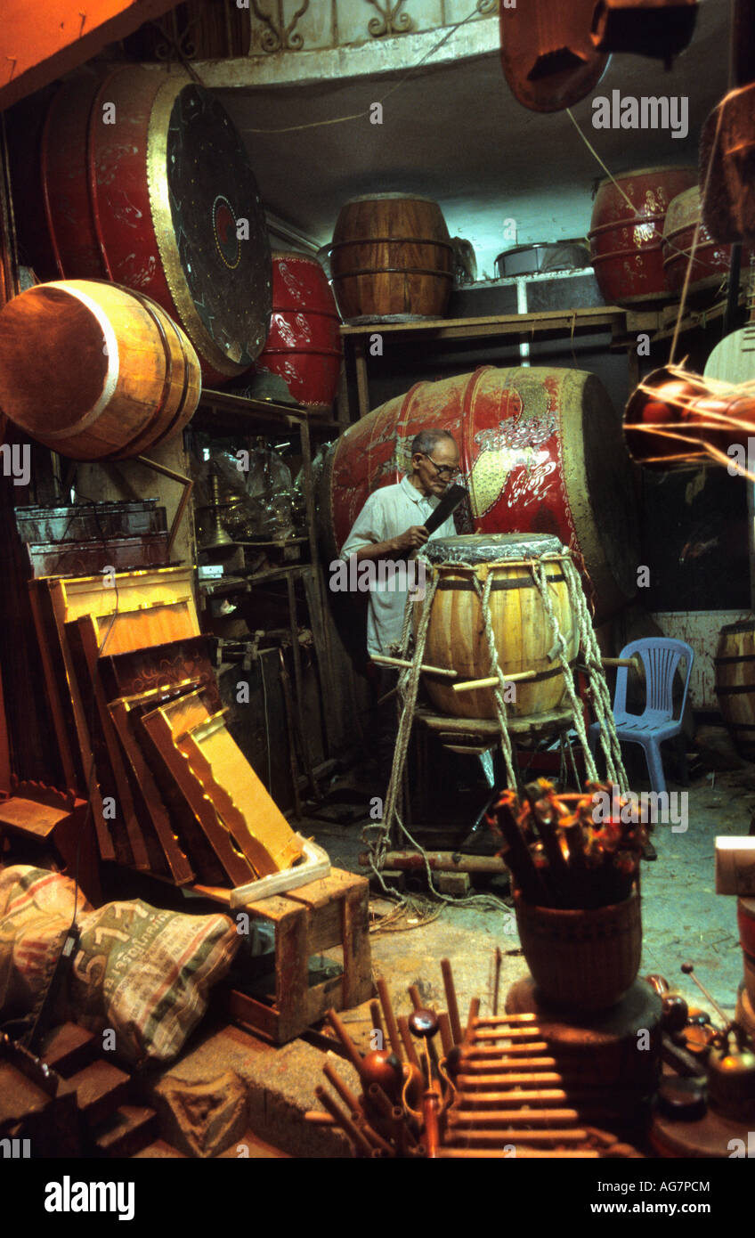 Vietnam Hanoi Man repairing drums Stock Photo
