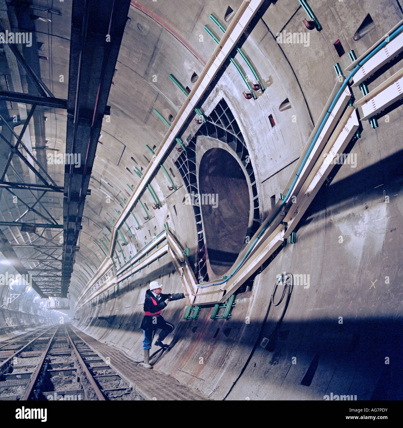 Channel Tunnel Engineer examines a Piston Relief Duct (PRD) used for