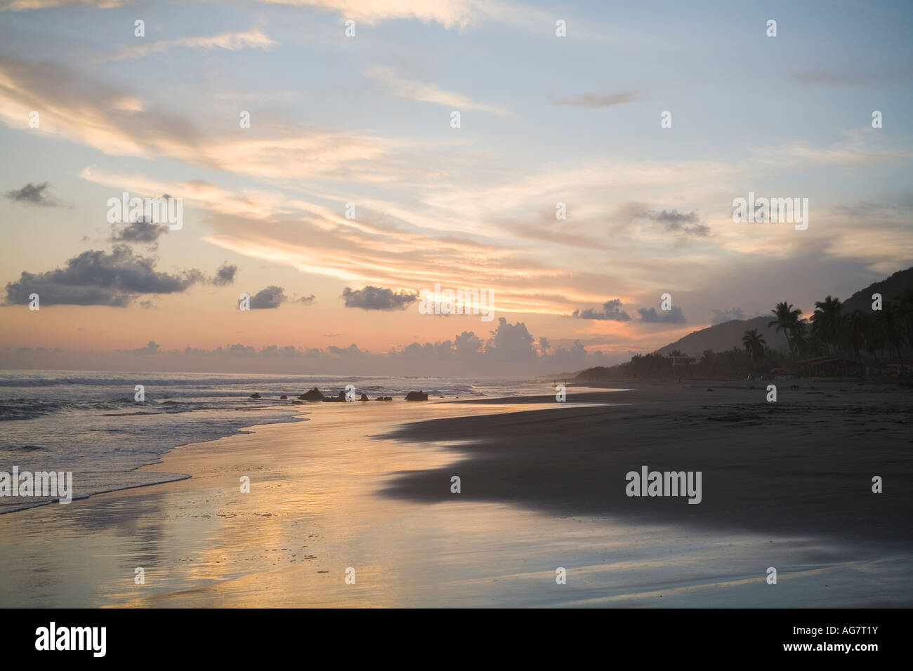 A glorious sunset is reflected in the surf on Troncones Beach, State of Guerrero, Mexico. Stock Photo